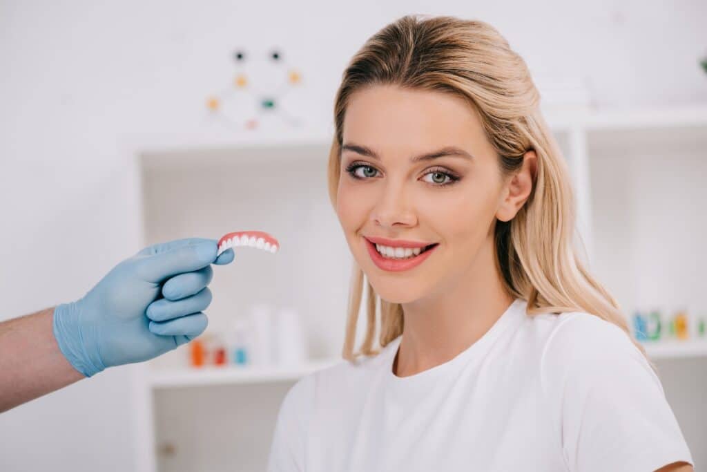 Patient smiling after dental bonding treatment with natural-looking teeth